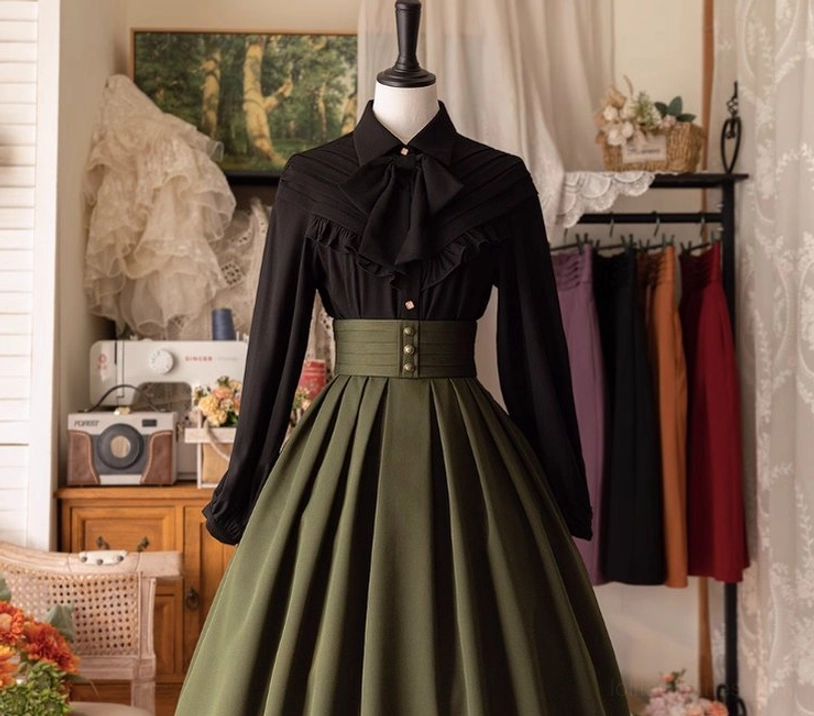 Black Lolita bow blouse sleeve detail showing long tailored puff sleeves with gathering at wrist, statement bow necktie, and slim metal buttons on aristocratic vintage-inspired design