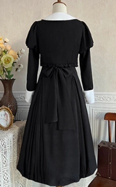 Detail shot of black Lolita dress coat showing construction quality, fabric texture, and fit proportions of the matching coat piece from collection