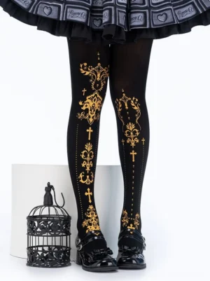Black lolita foil print tights with gold floral cross pattern worn with gothic lolita skirt and birdcage prop front view