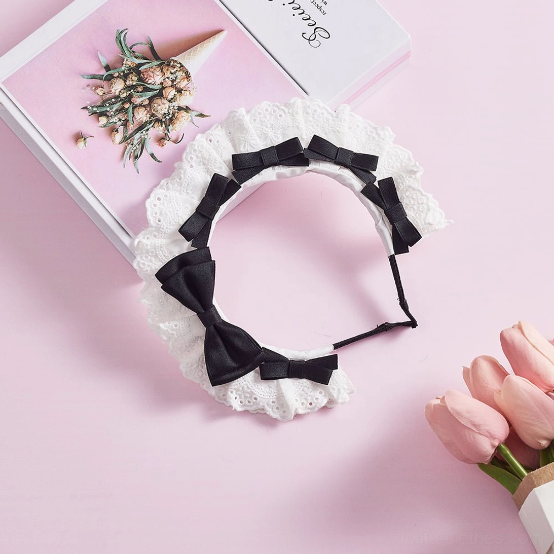 Black satin bow lolita lace KC headband overhead flat lay view showing metal headband base white hollow lace trim and structured bow design