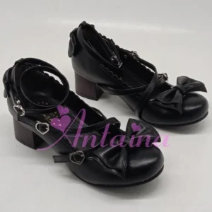 Black handmade lolita high heel shoes with smooth leather finish, crossover ankle straps, heart-shaped metal buckles, and side zipper for easy wear, pair showcase on white background