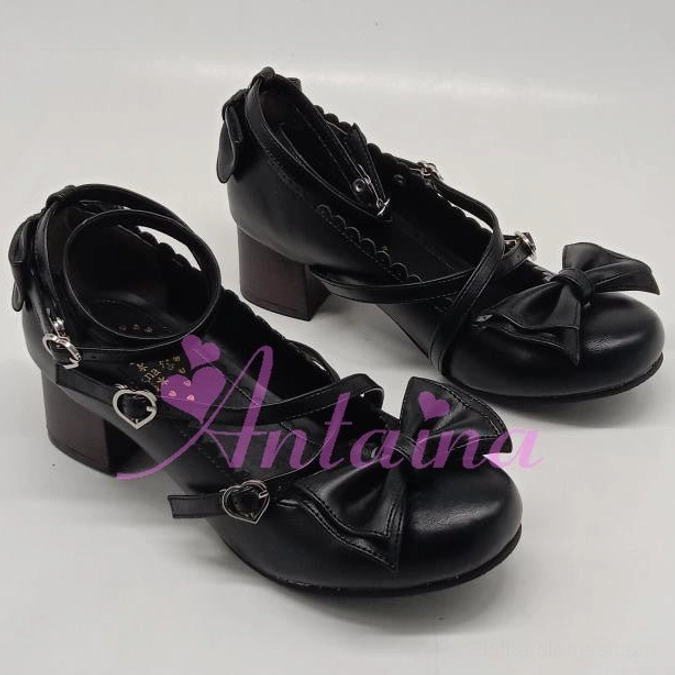 Black handmade lolita high heel shoes with smooth leather finish, crossover ankle straps, heart-shaped metal buckles, and side zipper for easy wear, pair showcase on white background