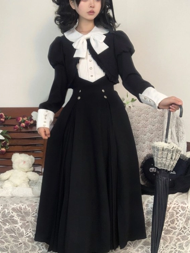 Black Lolita OP dress showing back view with floor-length pleated skirt design, demonstrating silhouette structure and fabric drape characteristic of Gothic Lolita fashion