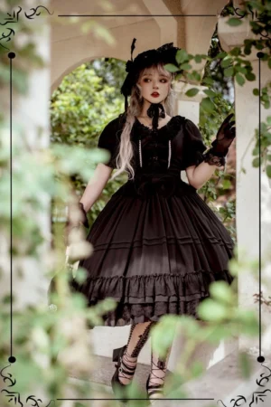 Black lolita elegant OP dress full body view with model in archway wearing vintage hat and stockings