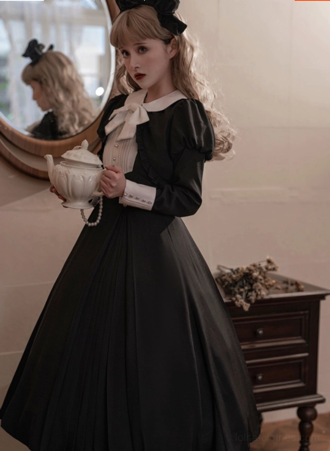 Black Lolita one-piece dress waist detail showing high-waisted buttoned bodice, white contrast placket, and pleated skirt attachment characteristic of Gothic Lolita silhouette