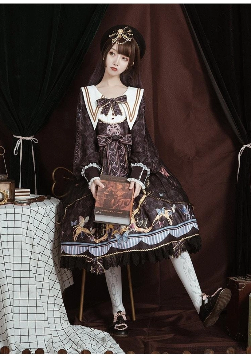 Black sailor collar lolita op dress front detail shot, three red heart-shaped buttons, white sailor collar gold trim, front tulle overlay with scalloped edging, lace ruffles