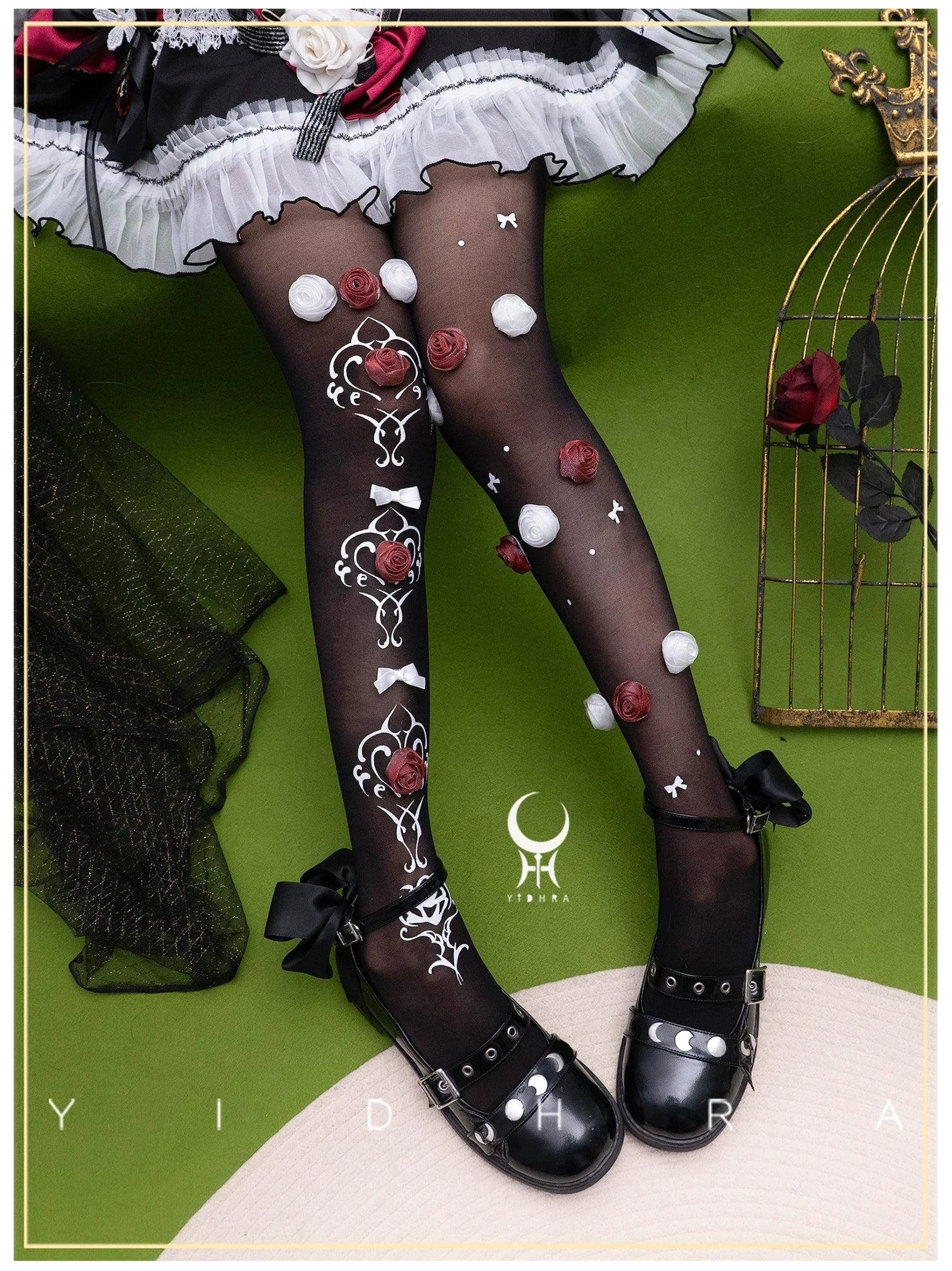 Black lolita pantyhose with handcrafted roses white embroidery bows flat lay photography showing decorative details with gothic aesthetic styling