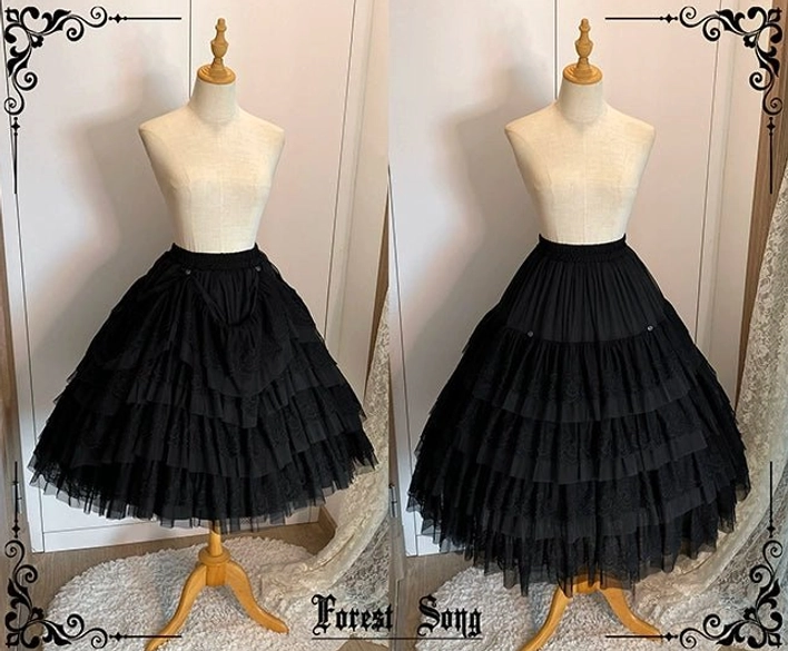 Two black lolita petticoats front view on wooden mannequins showing solid black tulle layered ruffles with full dramatic voluminous silhouette for gothic lolita