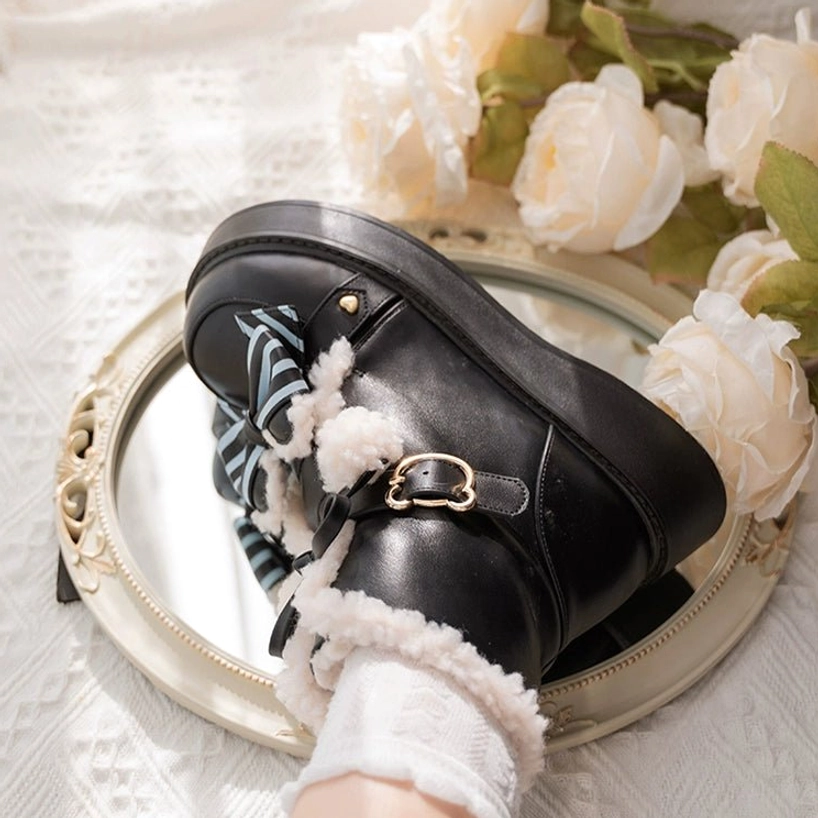 Black lolita winter snow boots close-up detail showing construction quality leather exterior fuzzy collar decorative elements