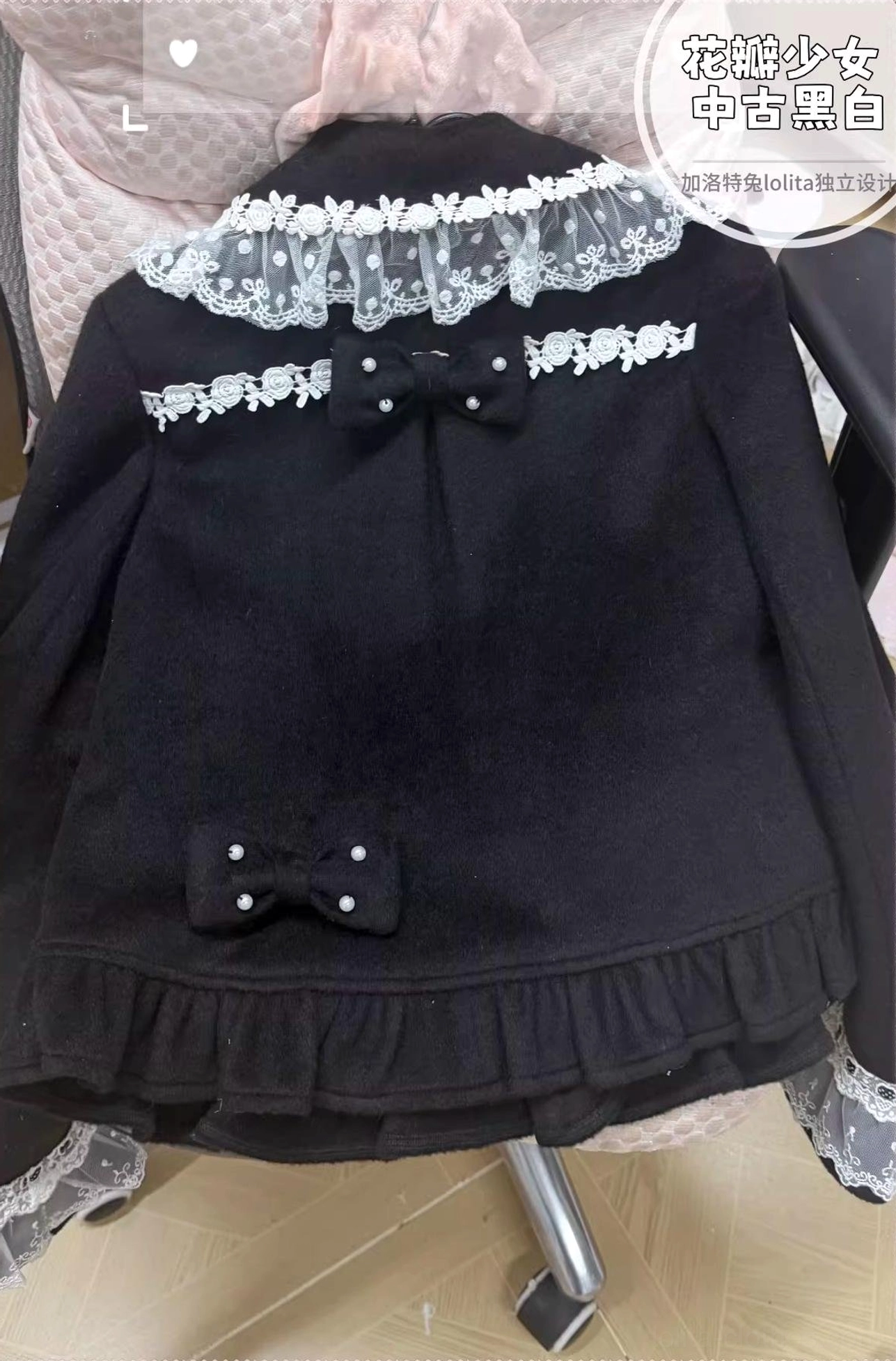 Back view of black lolita wool coat showing lace collar trim small bow and ruffled bottom hem with tiny waist bow decoration