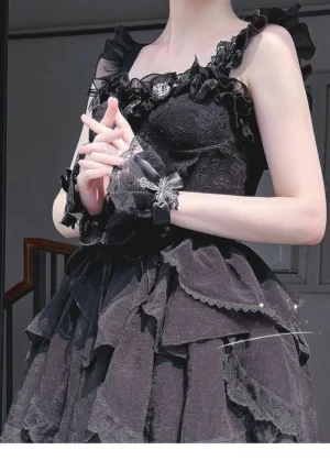 Black cross-decorated lace bow wrist cuffs with silver ornament detail on model in stairwell setting