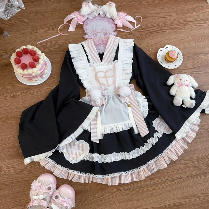 Black maid lolita ensemble back view showing oversized bow and cross back strap construction detail