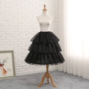 Black multi-tiered Lolita puffy petticoat front view on wooden mannequin, dramatic ruffled tulle layers with scalloped hem edge