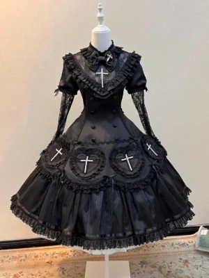 Black Nocthymn Cross Gothic Lolita OP dress front full view on dress mannequin featuring pearled heart cross details and layered ruffled skirt