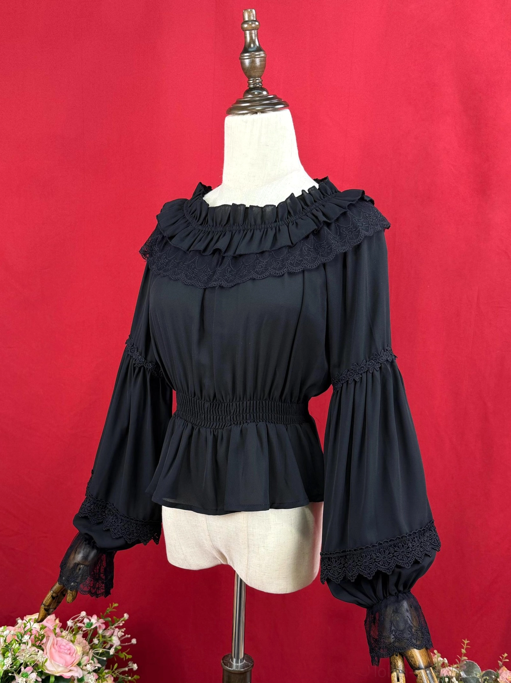 Black off-shoulder Lolita blouse side profile showing bell sleeves with lace cuffs elasticated waist silhouette from left angle