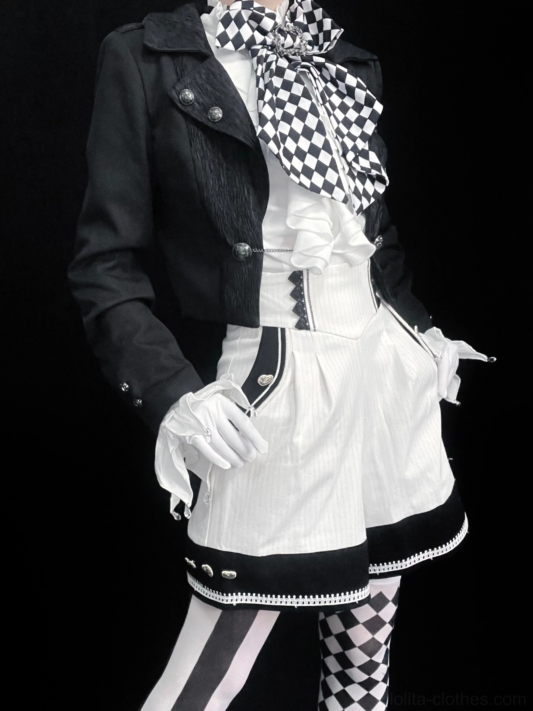 Alternative themed Ouji Lolita outfit featuring black cropped open front coat with checkered ruffled ascot, white ruffled blouse and shorts, formal styling coordination