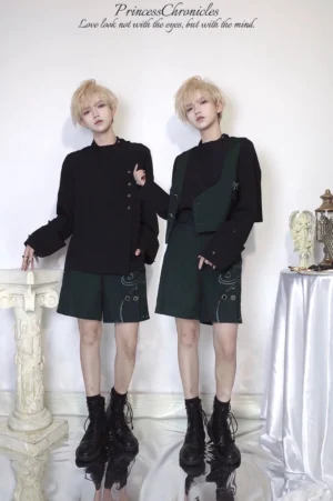 Retro Ouji Lolita prince style black blouse worn by twin blonde male models in vintage studio with roman column props, full-body front view