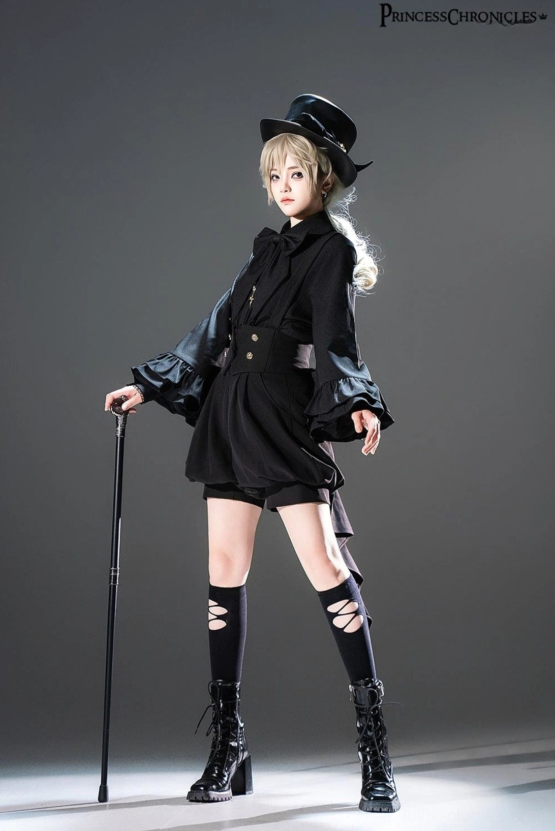Black Ouji Lolita coordinate with detachable bow tie shirt, bishop sleeves, high waist shorts, top hat, walking cane, and fitted waistline exemplifying prince lolita formal style