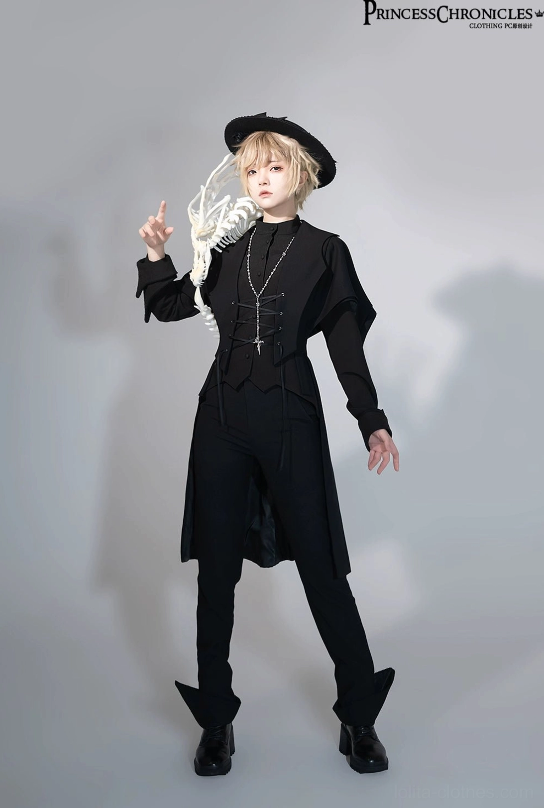 Straight full-body front view of black Ouji Lolita formal swallowtail vest worn by blonde male model on grey studio background with slim tailored silhouette and lace-up front corset design