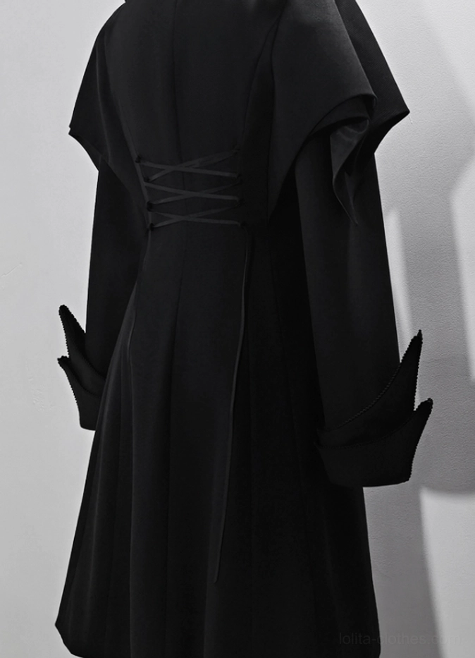 Black swallowtail Ouji Lolita long vest paired with decorative accessories including cross pendant and black bow hat showing complete formal Ouji coordinate assembly