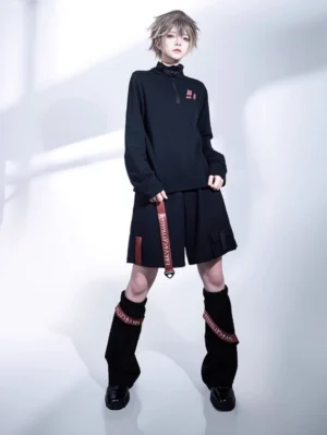 Black Ouji Lolita wasteland shorts and leg warmers full body coordinate set front view with androgynous model in white studio wearing complete techwear Gothic Lolita outfit with red webbing details