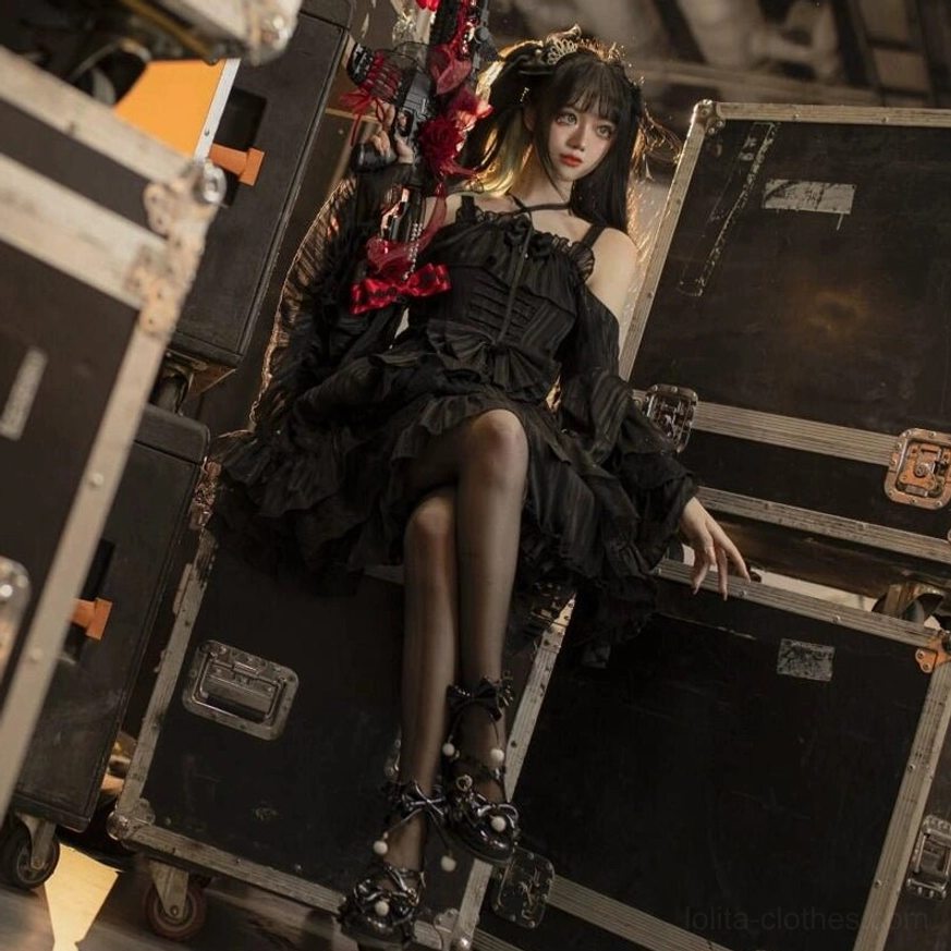 Black paint mid-heel Lolita Mary Jane shoes with butterfly bows, worn with black gothic Lolita dress and stockings, eye-level studio portrait shot with vintage trunk props