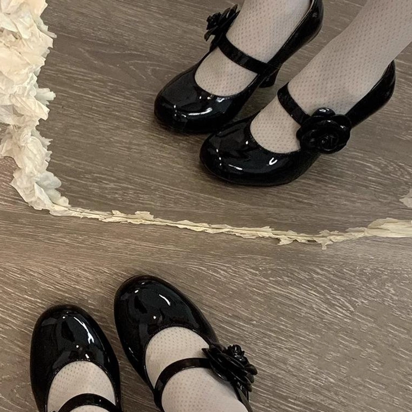 Black patent leather Lolita Mary Jane high heels first-person overhead view of wearing feet on wooden floor with ruffled fabric border sheer dotted stockings block heel rose strap