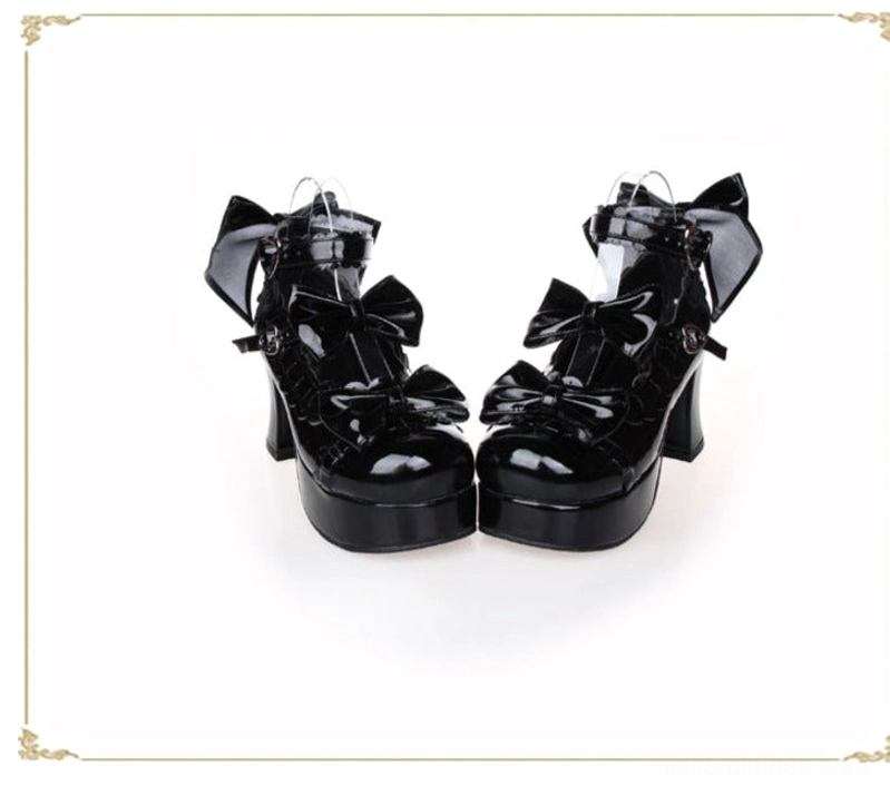 Black patent leather lolita platform heels shiny surface multiple bow details chunky platform heel heart-shaped ankle buckle golden frame