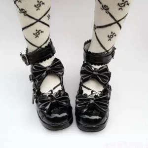Black patent leather lolita bow mary jane heels on model wearing cross-pattern knee socks ankle buckle straps close-up