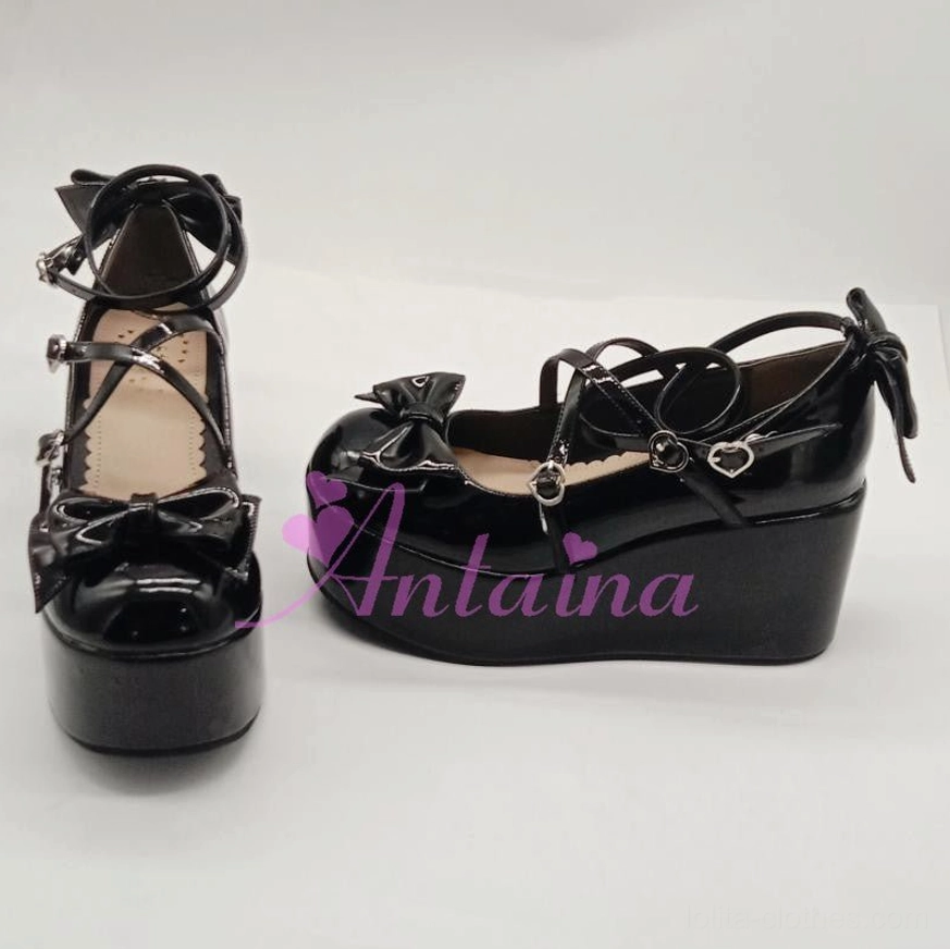 Black patent Lolita platform shoes dual-angle display showing single shoe from multiple perspectives with bow decorations, heart-shaped metal buckles, and thick platform on white background