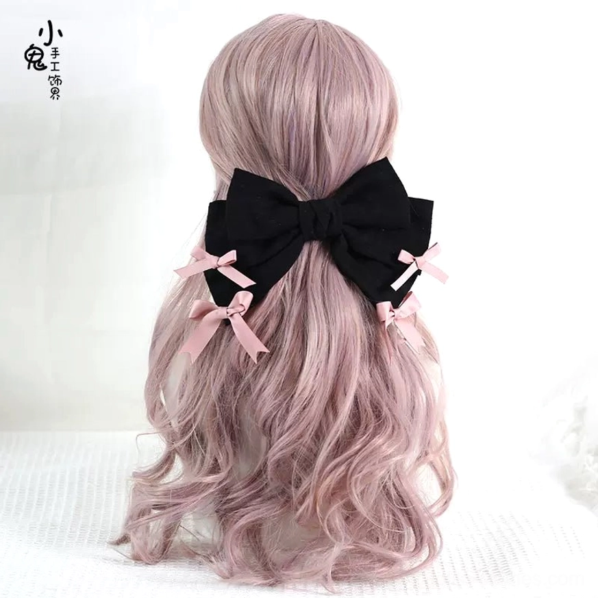 Black bowknot back hair clip for sweet lolita fashion back view on pink curly wig mannequin with pink bow trims minimalist styling