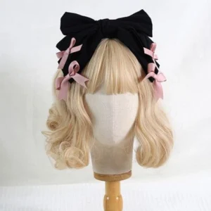 Black bowknot lolita hair headband with four pink satin bow decorations on blonde mannequin head front view lolita fashion accessory