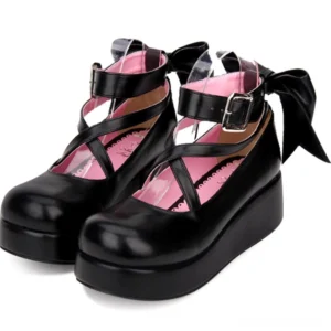 Black platform Lolita leather shoes with crisscross ankle straps and large back bow three-quarter front view studio shot