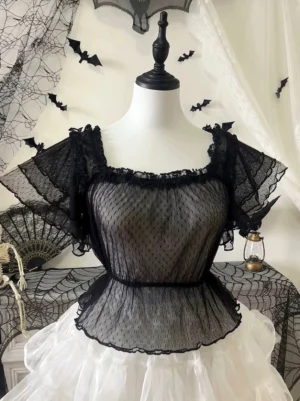 Black polka-dot sweet Lolita blouse with tiered flutter sleeves and frill collar, front view on mannequin with Halloween backdrop