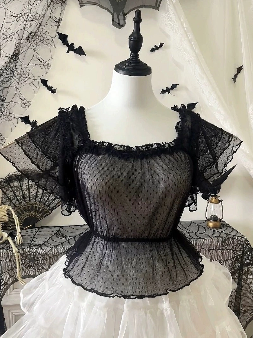 Black polka-dot sweet Lolita blouse with tiered flutter sleeves and frill collar, front view on mannequin with Halloween backdrop
