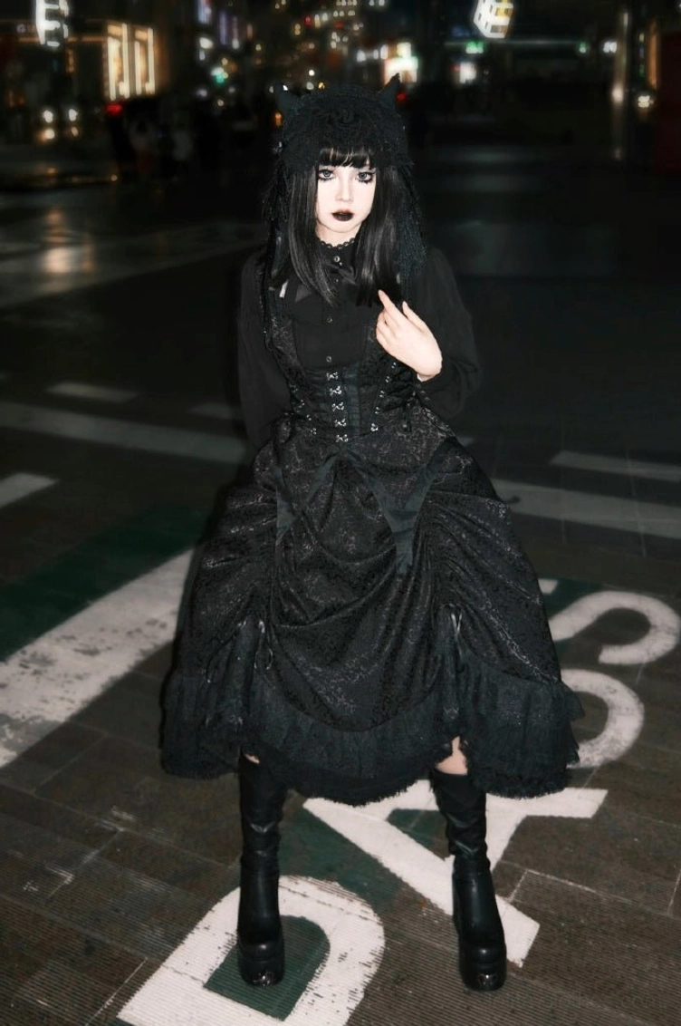 Black-purple gothic lolita vest variant showcasing purple decorative corset trim accents, black base construction, side lacing detail, butterfly hemline, and modern color-blocking aesthetic