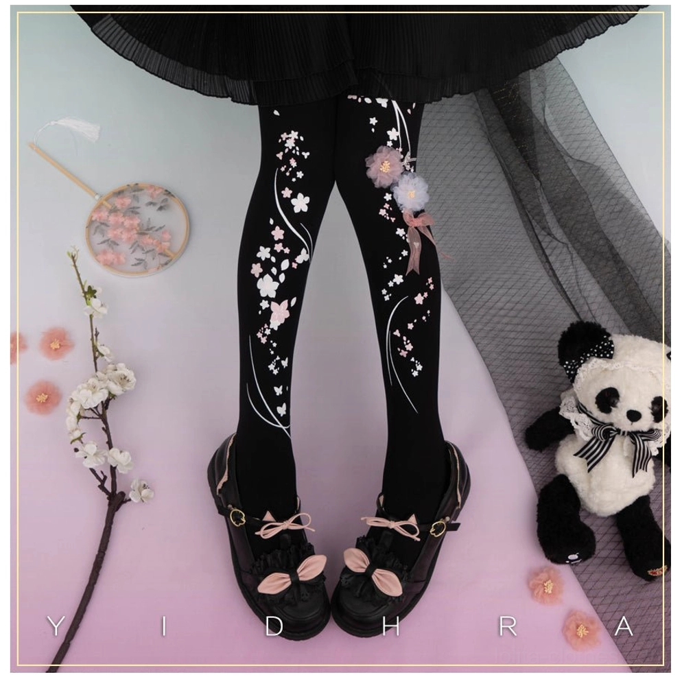 Black qi lolita pantyhose cherry blossom vine print with pom-pom embellishments front view gradient backdrop coordination