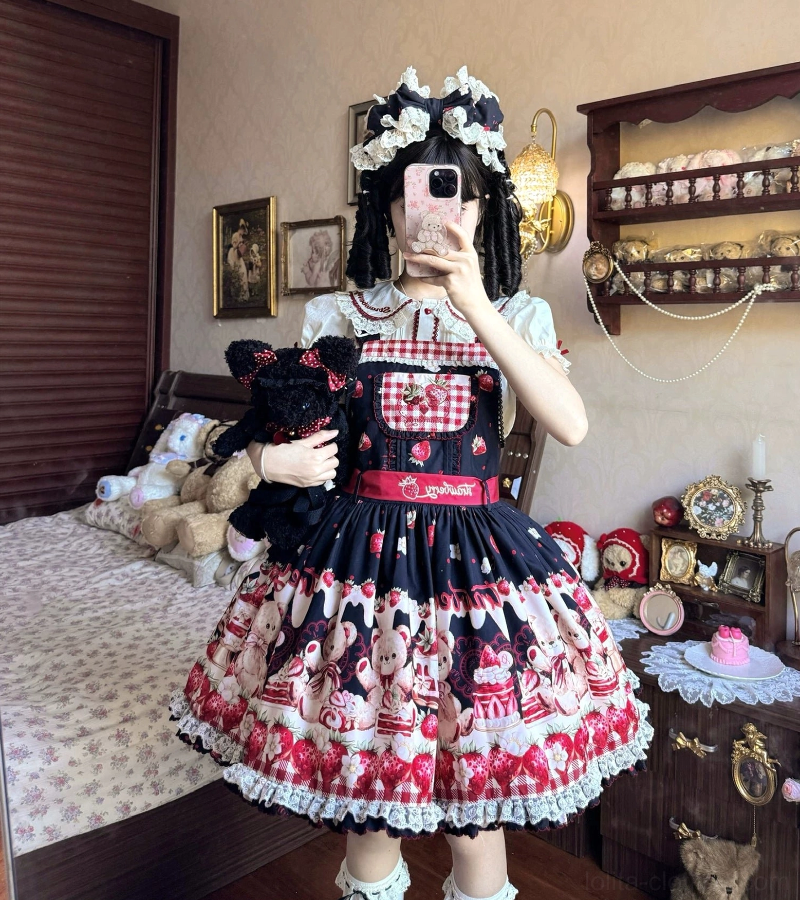 Black-red sweet lolita salopette jsk close-up showing ruffled lace hem, all-over bear and strawberry prints, detachable waist bow detail bedroom photo shoot