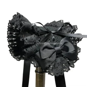 Black Rococo lace lolita headband with satin bow and ribbon details displayed on wooden stand side-front view