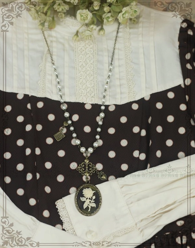 Black rose cameo lolita necklace worn styling black polka dot lolita dress white lace blouse on body
