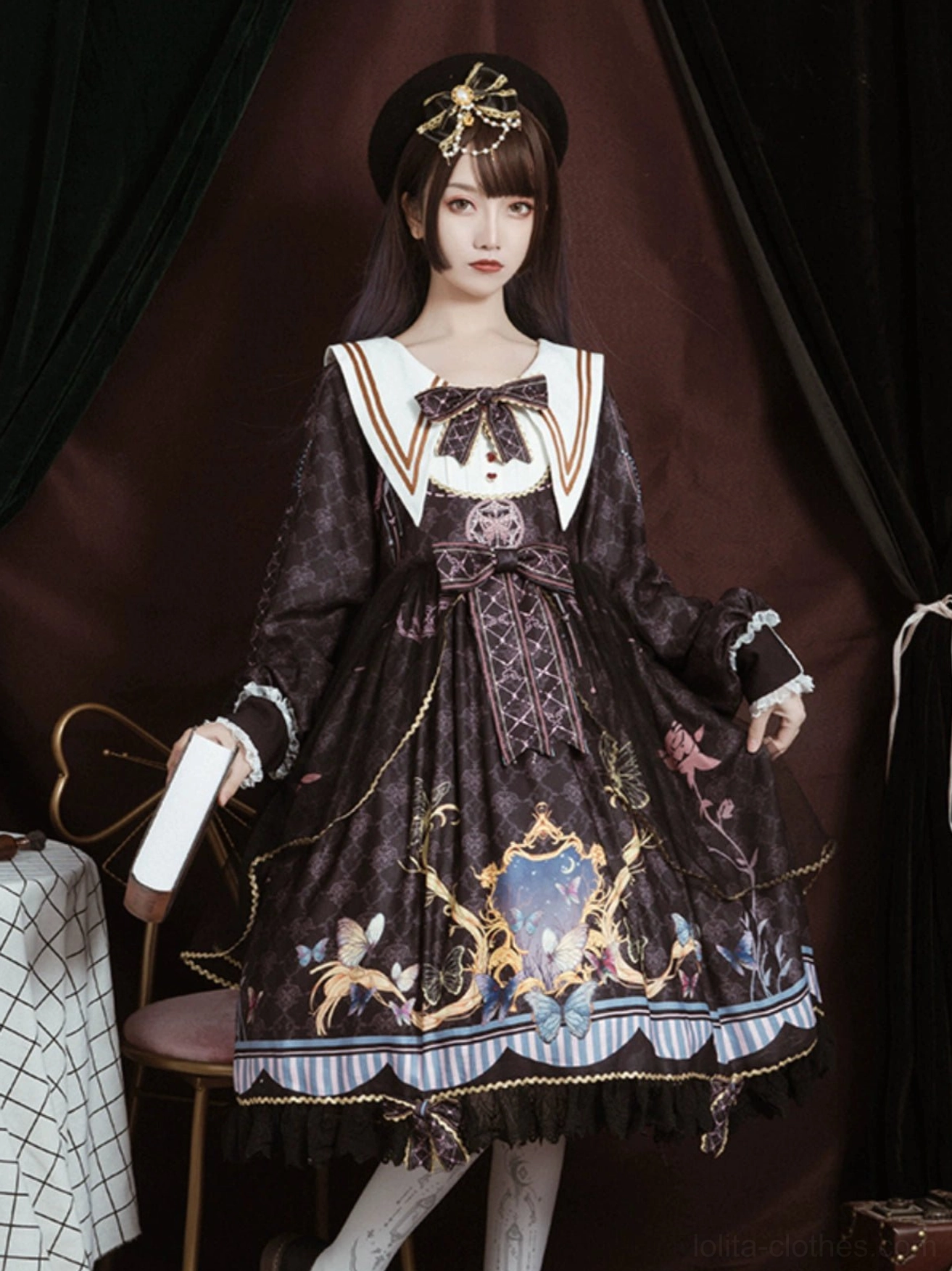 Black sailor collar lolita one-piece dress full-body standing view on model, white sailor collar with gold trim, detachable bow elements at collar waist and hem, lace underskirt, baroque print