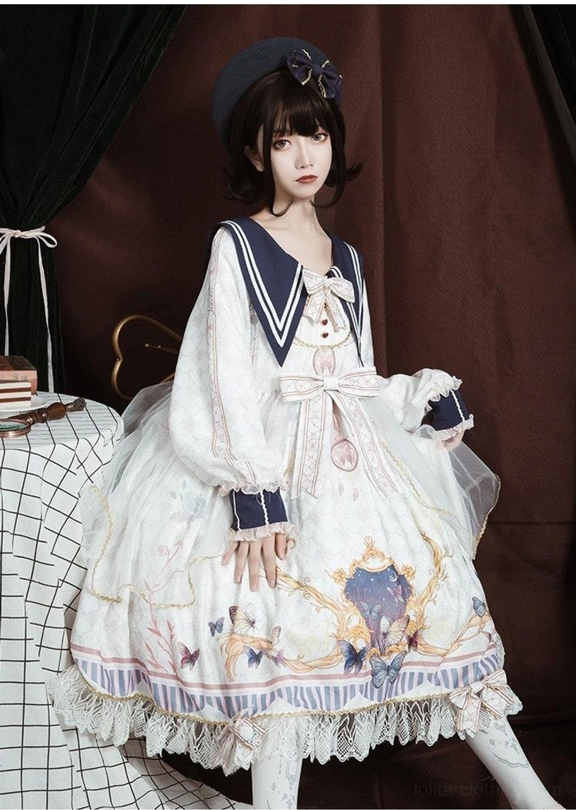 Black sailor collar lolita one-piece dress front full-body view on model, black base fabric with baroque print, white sailor collar with gold trim, detachable bows at collar waist and hem
