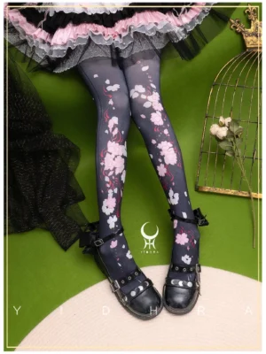 Black sakura print Lolita pantyhose 120D with pink and white cherry blossom design paired with dark pink and black frilly Lolita skirt and black bow Mary Jane shoes on decorative background with birdcage