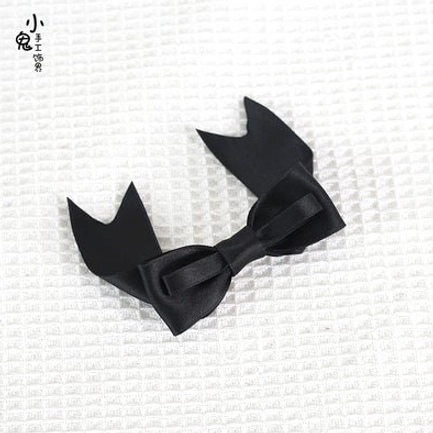 Black satin bow hair clips glossy finish split-tail design top-down flat lay showing solid black color for gothic lolita fashion