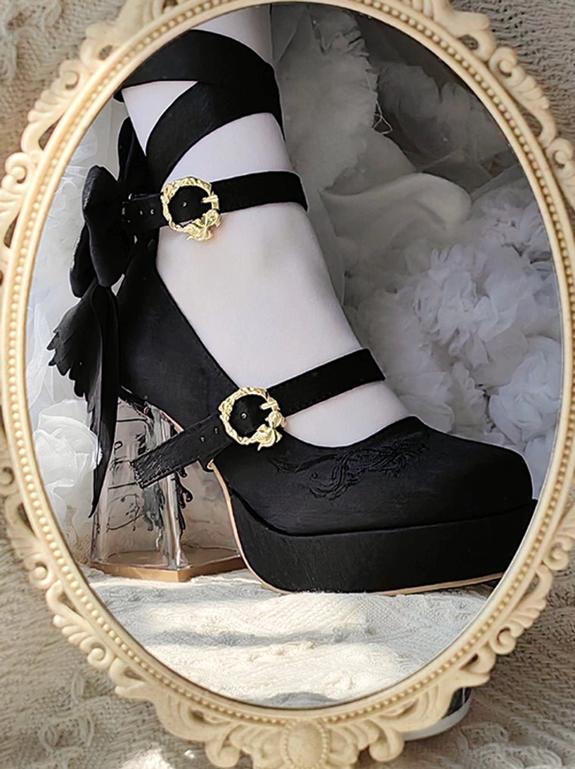 Black satin classic lolita platform heels with gold heart buckles and transparent block heel close-up mirror reflection