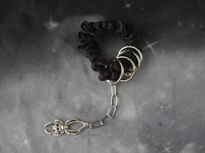 Black gothic hair scrunchie with metal rings and skeleton lobster clasp chain detail