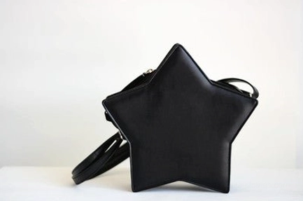 Matte black five-pointed star Lolita crossbody bag three-quarter view, Gothic Lolita style with black leather shoulder strap and compact star design