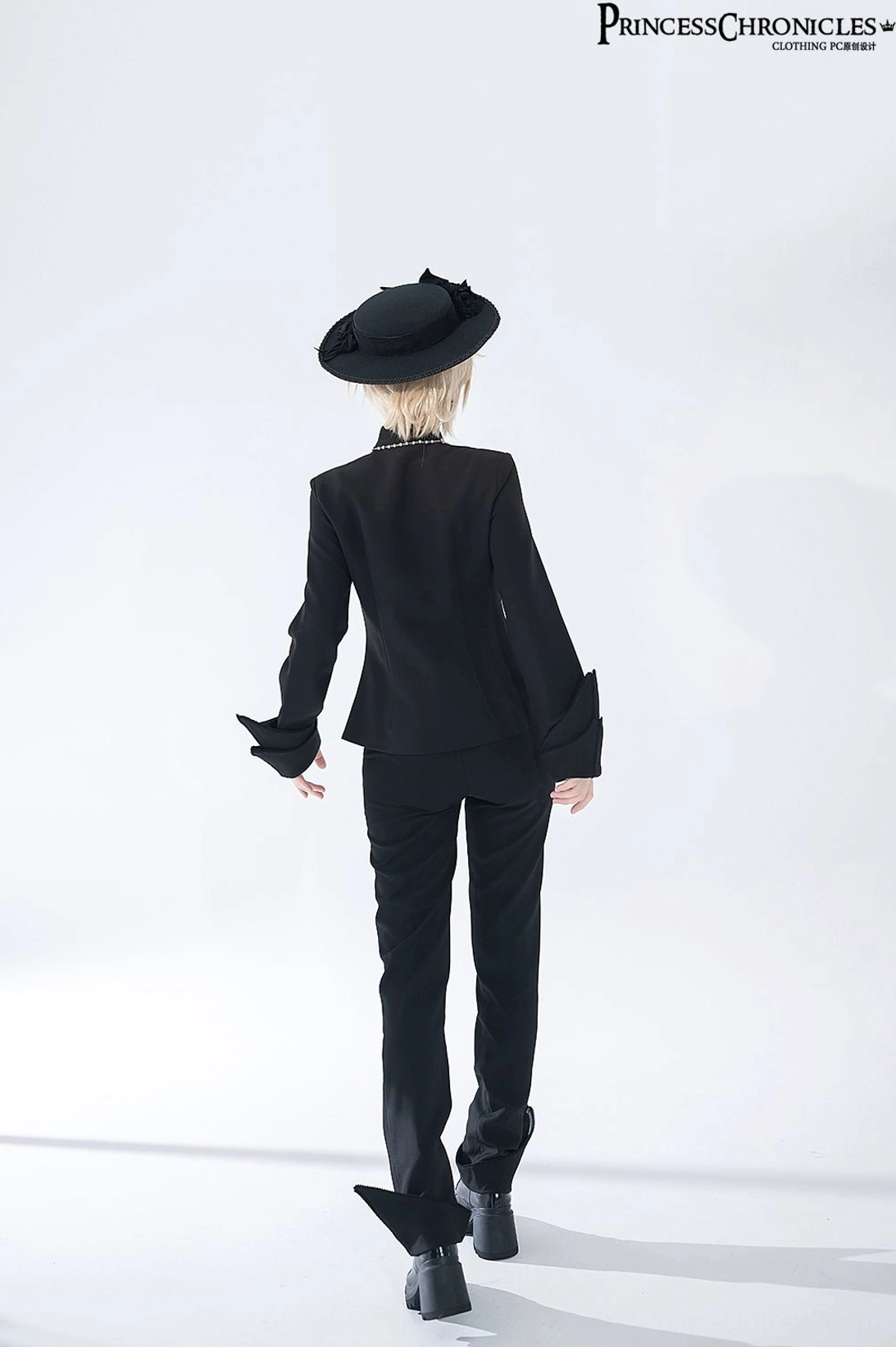 Black swallowtail Ouji Lolita long vest styling guide showing coordinated outfit assembly with formal trousers and traditional Ouji aesthetic accessories for convention wear