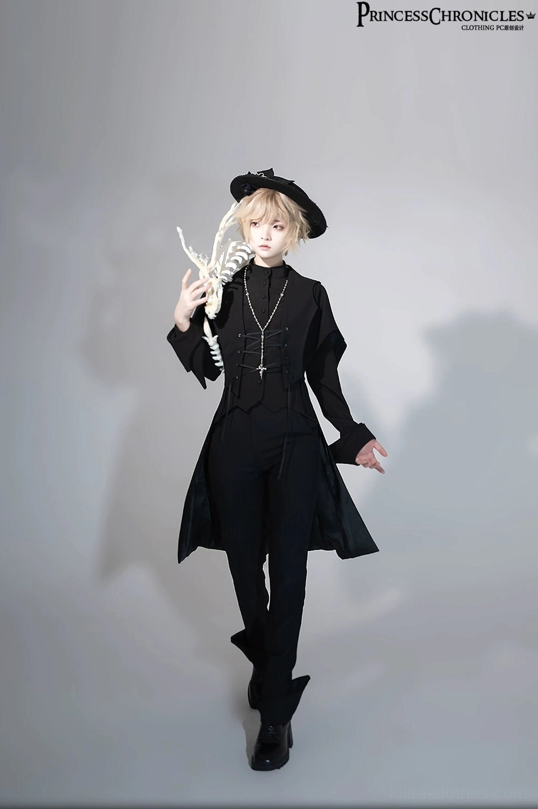 Walking full-body front view of black swallowtail Ouji Lolita tailcoat vest on model with black bow hat and formal styling, mid-length asymmetrical hem and leather formal boots visible