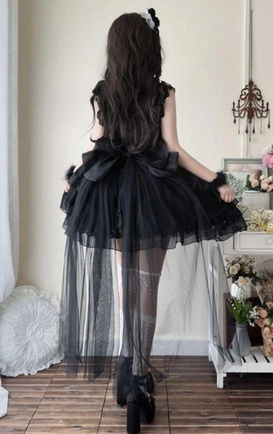 Black sweet lolita JSK dress with detachable floor-length tulle train and oversized back bow, back full-body view with black stockings and platform heels